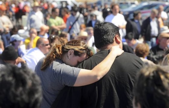 Tina Villareal leans on Nelson Alvarado while waiting to return to her home in a fire-ravaged San Bruno, Calif., neighborhood on Sunday.